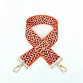 Adjustable wide woven shoulder strap with orange and black chevron pattern and gold clips - Orange