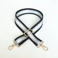Close-up of adjustable black and silver striped bag strap with gold metal swivel hooks - Black