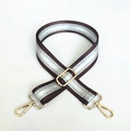 Macro shot of adjustable brown and silver woven strap with polished gold-tone metal buckles - Brown