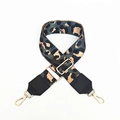 Close-up of leopard print wide crossbody strap with gold metal hooks and black leather ends - Gray