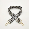 Close-up of adjustable woven shoulder strap with black and white diamond patterns and gold hooks - Blue