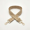Detail of adjustable geometric ethnic style woven strap with golden swivel hook hardware - Brown