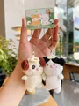 Detail of plush bear and cat charms with golden chains and delicate embroidery - Dog