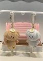 Detail view of plush bear pendants with fried egg headbands and golden chains - Baking Dog