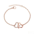 Detail of rose gold double heart bracelet with clear rhinestones on a delicate chain - Bracelet / Rose Gold