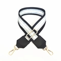 Close-up of black and silver striped adjustable shoulder strap with gold lobster clasps - Black Silver