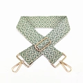 Detail view of woven geometric diamond purse strap with polished gold swivel hooks - Matcha Green