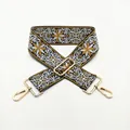 Close-up of ethnic embroidered bag strap with gold metal buckles on a white background - No. 46