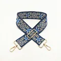 Close-up of ethnic style wide strap with blue geometric embroidery and gold hardware - No. 47