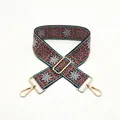 Close-up of ethnic woven adjustable shoulder strap with floral patterns and gold metal clips - No. 49