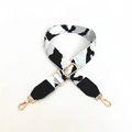 Detail of adjustable leopard print bag strap with golden metal lobster clasps and buckles - White + Black Leather
