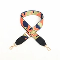 Detail of adjustable camouflage canvas bag strap with gold metal swivel hooks and buckles - Orange + Black Leather