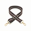 Close-up of brown arrow jacquard bag strap with adjustable buckle and gold metal hooks - Brown
