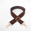 Detail of adjustable houndstooth bag strap with gold rotating metal lobster clasps - Brown