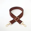 Detail of adjustable orange and black houndstooth bag strap with gold metal hooks - Brown Coffee