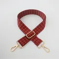 Detail of adjustable houndstooth bag strap with gold metal lobster clasps and buckle - Red