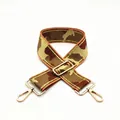 Detail of adjustable camouflage bag strap with wide webbing and gold swivel metal hooks - US 8