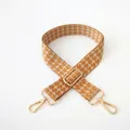 Detail of orange and beige houndstooth adjustable guitar style bag strap with gold clips - Yellow