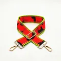 Close-up of wide camouflage jacquard bag strap with neon green trim and gold alloy buckles - US 11