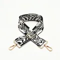 Detail of adjustable black and white geometric pattern wide bag strap with gold metal hooks - Style 10 Black White