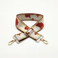 Detailed macro view of camo jacquard strap with gold metallic thread and hardware - Size 17