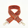 Detailed weave of geometric orange and black bag strap with gold metal lobster clasp - No. 1 Orange
