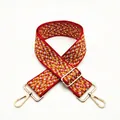 Detail of red and yellow zigzag woven bag strap with adjustable gold metal hardware - No. 8 Red