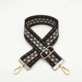 Detail of adjustable wide shoulder strap with brown geometric chevron pattern and gold hooks - Coffee (B1)