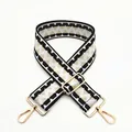 Close-up of wide geometric pattern strap with gold buckles and lobster clasps - Black Khaki (B7)