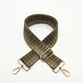 Detail of bohemian woven bag strap with green and brown geometric pattern and gold buckle - Green