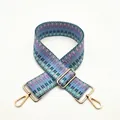 Macro shot of colorful geometric woven bag strap with golden metal hardware adjusters - Lake Blue