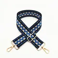 Detail of adjustable wide shoulder strap with blue and beige geometric pattern and gold clips - Blue (B12)