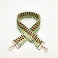 Macro detail of a colorful woven replacement shoulder strap with gold metal lobster clasps - Light Green
