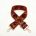 Detail of adjustable geometric wide strap in orange and black with gold metal hooks - a7 Orange