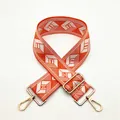 Close-up of adjustable wide bag strap with orange and white geometric diamond pattern - a20 Light Orange