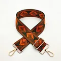 Close-up of geometric jacquard shoulder strap with golden metal clips and adjuster - a24 Orange Green