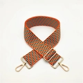 Detail of adjustable woven bag strap with orange and blue geometric pattern and gold buckle - Orange