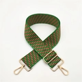 Close-up of adjustable woven shoulder strap with green and red geometric pattern and gold buckles - Green