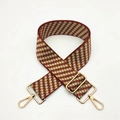 Detail of red and yellow geometric diamond pattern fabric strap with gold metal hooks - Brown