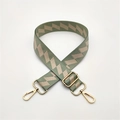 Detail of green and beige geometric woven bag strap with golden metal swivel hooks - Matcha Green