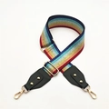 Close-up of rainbow striped wide bag strap with gold metal hooks and glitter thread - Multicolor + Green Leather