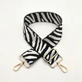 Detail of adjustable zebra stripe wide bag strap with luxury gold metal hardware - No. 43 White