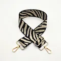 Close-up of zebra pattern wide strap with adjustable golden metal hardware for bags - No. 45 Beige