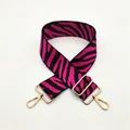 Close-up of a wide pink and black zebra pattern replacement strap with gold hardware - No. 49 Rose Red