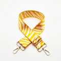Close-up of a wide yellow and white zebra pattern strap with gold metal hooks and buckle - Silver Clasp / No. 54 Yellow
