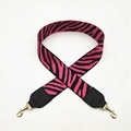 Close-up of zebra pattern handbag strap with black leather ends and gold metal hooks - Rose Red with Black Leather