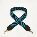 Detail of blue zebra pattern bag strap with black leather ends and golden metal hooks - Blue with Black Leather Trim