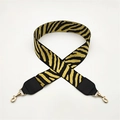 Close-up of zebra stripe wide bag strap with golden metal swivel hooks and black leather ends - Yellow with Black Leather Trim