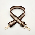 Close-up of brown and gold stripe replacement bag strap with adjustable metal buckle - Brown