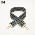 Macro detail of wide woven shoulder strap featuring green geometric patterns and gold metal hooks - Green and White Herringbone (04)